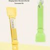 A yellow long-handled pet food dispensing spoon with a hanging loop, shown against a light background.