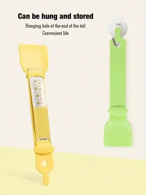 A yellow long-handled pet food dispensing spoon with a hanging loop, shown against a light background.