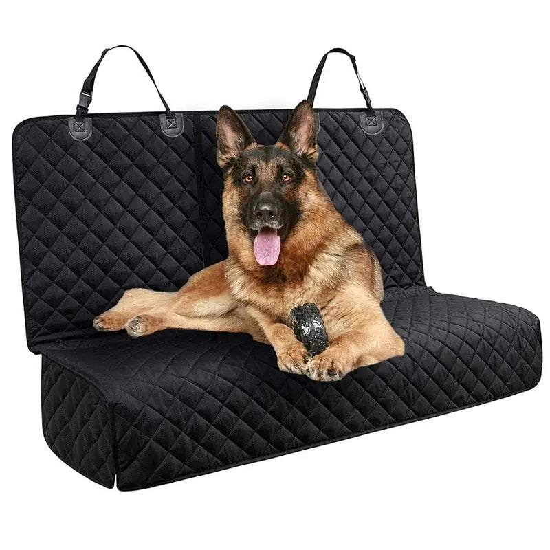 A German Shepherd dog is lying on a black waterproof car seat cover mat.