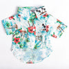 A short-sleeved shirt featuring a Hawaiian leaf print design with tropical flowers and foliage.