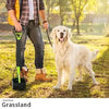 A person is using a portable foldable dog poop scooper to pick up dog waste on the grass.