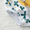 White reusable dog physiological pants with green floral patterns and yellow fabric visible.