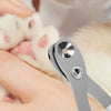 A hand is using stainless steel nail clippers to trim the nails of a white pet.