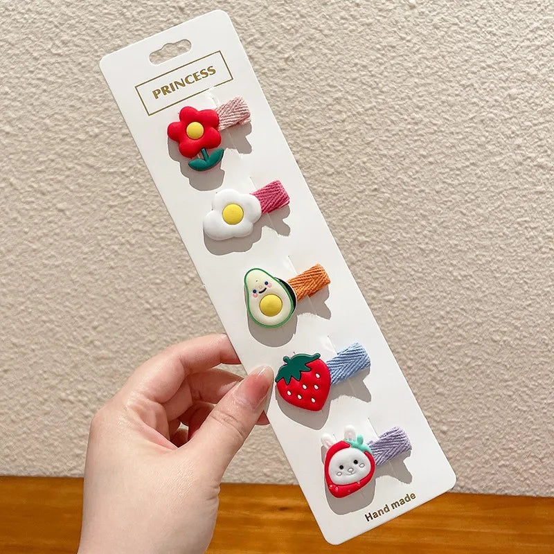 A white card displaying five adorable flower-shaped baby hair clips in various colors and textures.