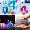 Various colored liquid droppers and vials arranged on a white surface.