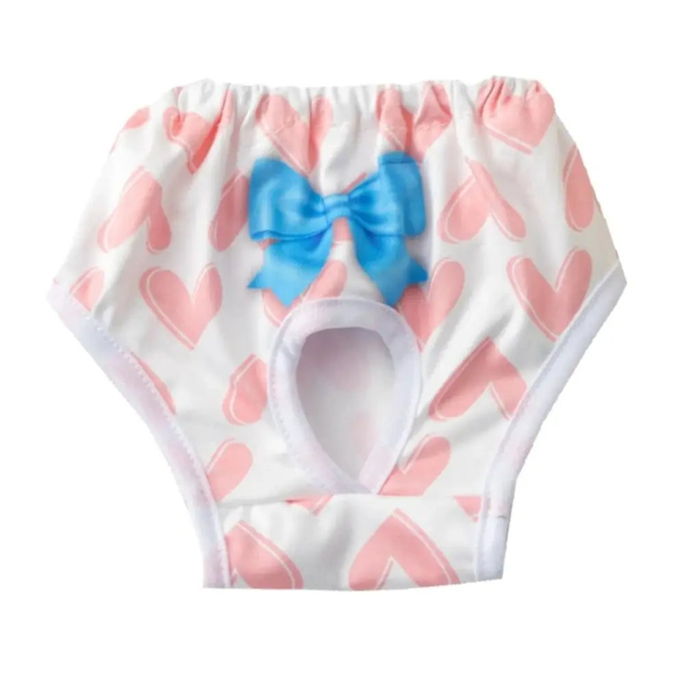 White reusable dog physiological pants with pink heart patterns and a blue bow.