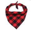A red and black plaid cotton dog bandana tied around the neck.