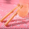 A silicone pet toothbrush set for cats and dogs with bristles is shown next to a clear storage case on a pink background.