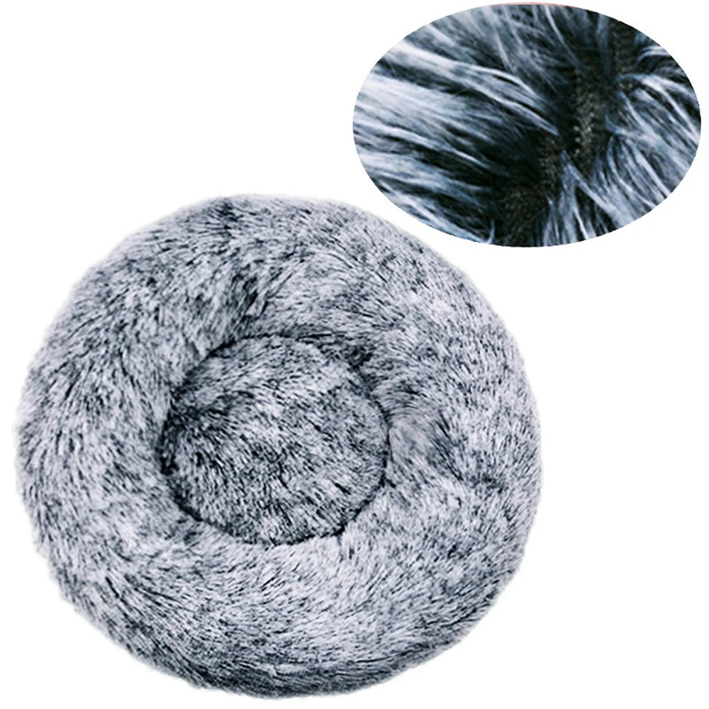 A plush round pet bed with a gray, fluffy cover and a circular inset showing close-up fur texture.