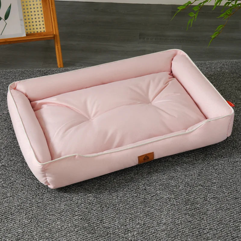 A pink premium corduroy pet sofa bed for dogs and cats lying on a gray carpet.