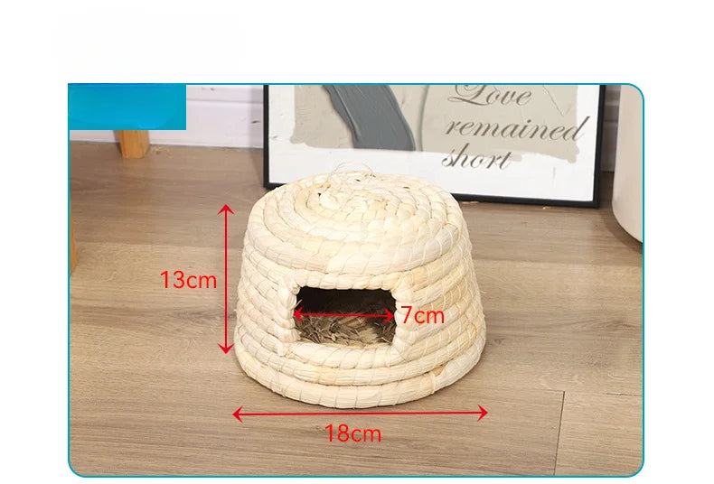 A natural straw woven mat with a dark entrance for small rodents, measuring 13cm high and 18cm wide.