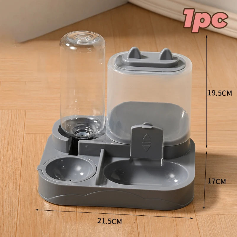 A gray automatic pet water and food feeder with a clear water tank and feeding compartment on a wooden surface.