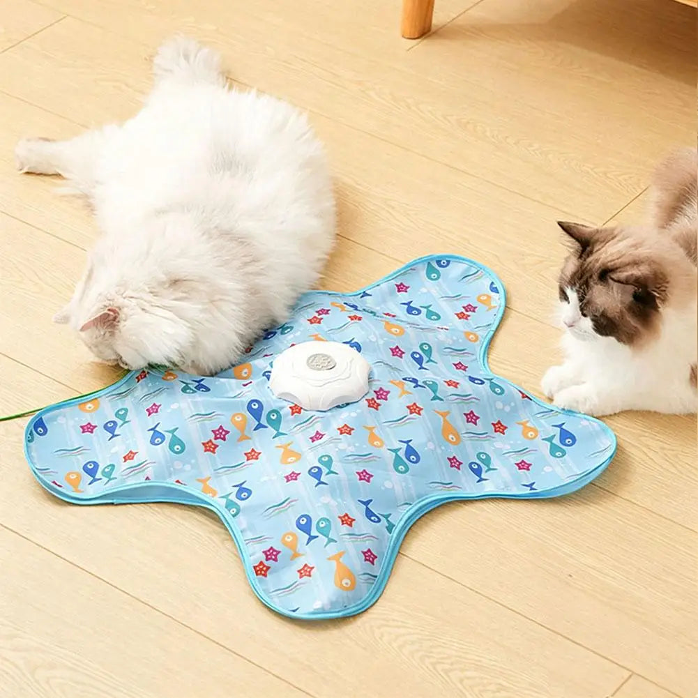 A light blue cat toy featuring a feather wand and various colorful accents, placed on a wooden floor next to two cats.