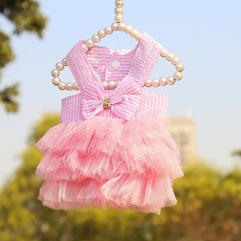 Pink summer pet dress for a small dog featuring ruffles and pearl detailing