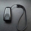 A black ultrasonic dog bark deterrent device with a strap is shown against a dark gray textured background.