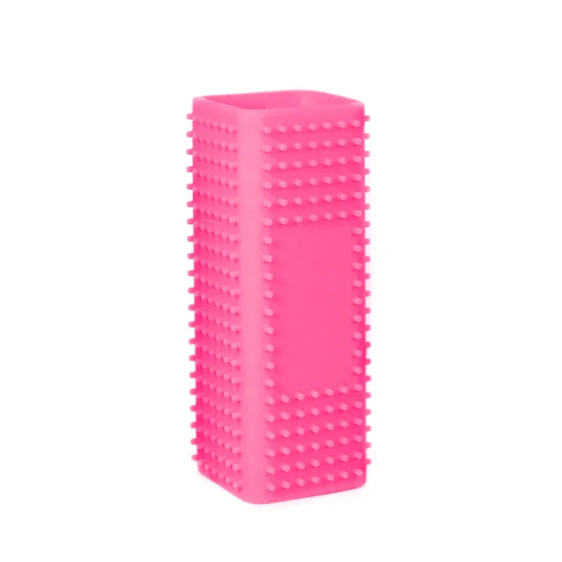 A bright pink pet hair removal brush with silicone hollow rubber bristles.