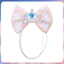 A pink and gold glitter princess style dog hair bow with a sparkling blue crown detail