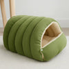 A lime green, ribbed plush cat cave bed with a removable beige lining is shown on a light surface.