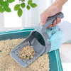 A hand is scooping pet litter from a tray using a gray reusable scoop and a blue waste bag.