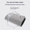 A gray, porous cat litter mat is shown with water dripping off it, demonstrating its waterproof property.