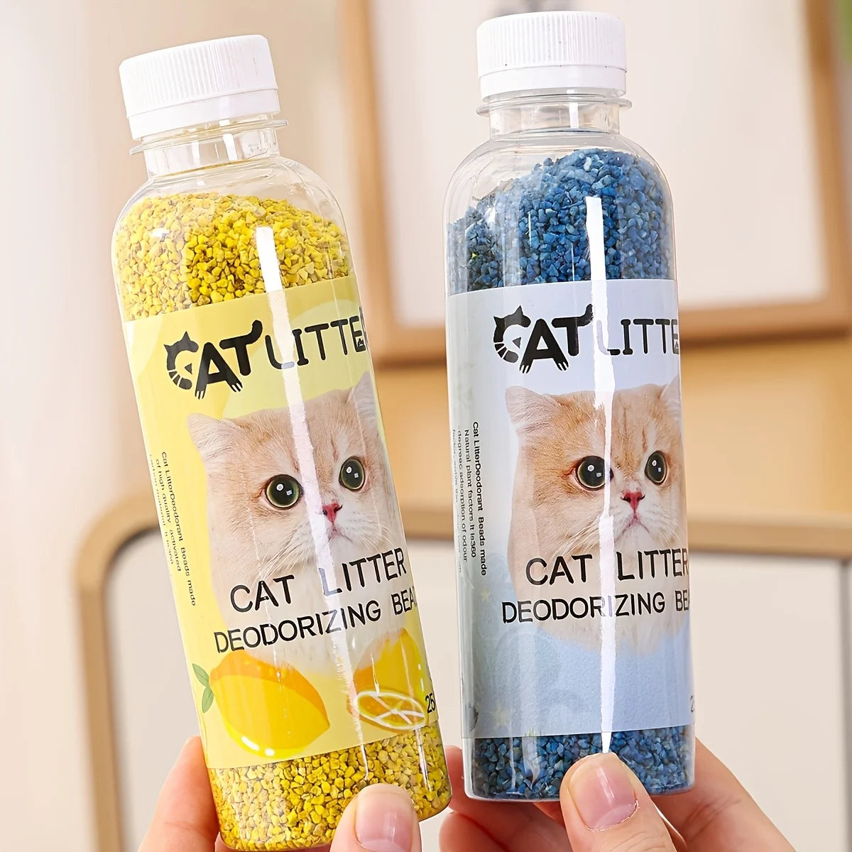Eine Hand hält eine Flasche Katzenstreu-Deodorierungsperlen in gelben und blauen Pellets.