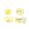 Yellow pet hair bow clips with white and gold accents for grooming accessories