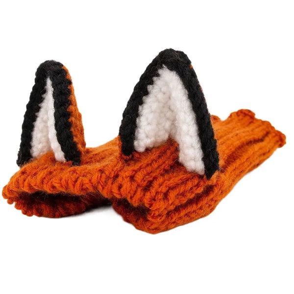 Orange knitted dog ear muffs with black and white accents
