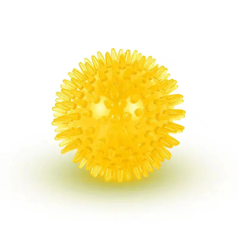 A bright yellow, spiky dog ball designed for teeth cleaning and play.