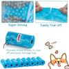 A roll of blue reusable pet poop bags with a leash clip and a small dog nearby.