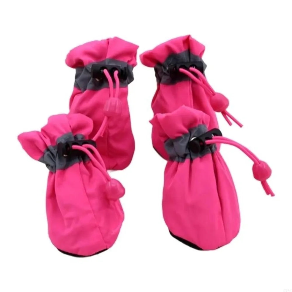 Pair of bright pink cozy anti-slip dog booties with black reflective grip