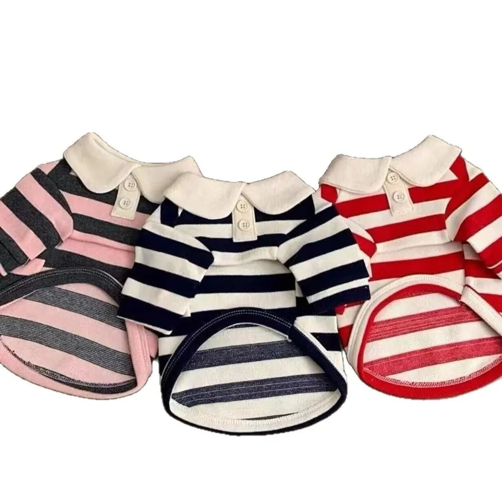 A set of three striped dog hoodies in pink, navy blue, and red.