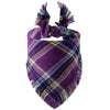 A purple and yellow plaid dog bandana with fringed edges.