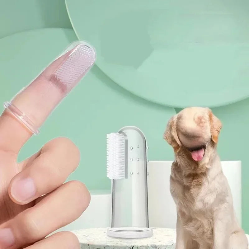 A hand holds a silicone pet toothbrush, showing the brush and a dog looking at it.