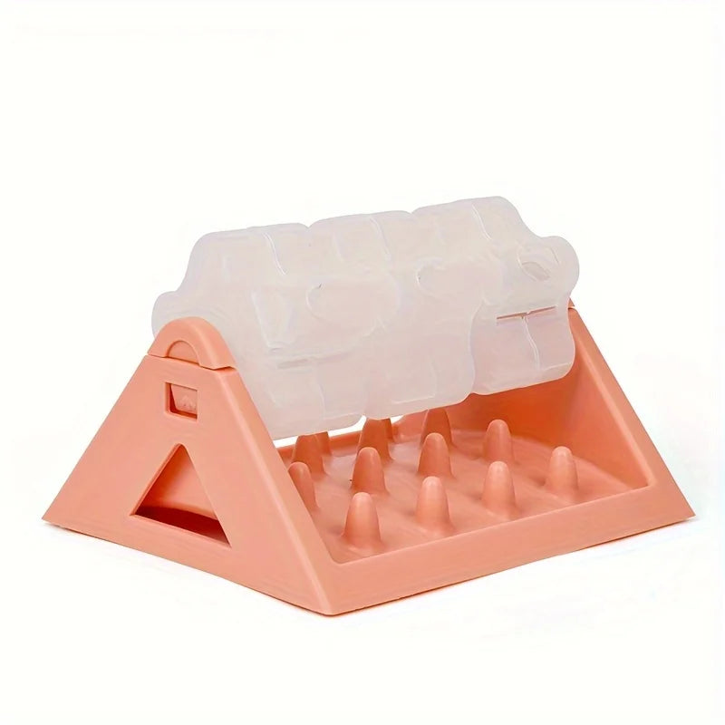 A pink interactive dog food puzzle dispenser with silicone feeding tubes and a triangular base.