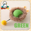A green automatic rolling interactive ball for cats surrounded by fluffy fur and a small yellow ball.