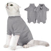 A white cat wearing a gray specialized recovery vest, with two vests shown separately.