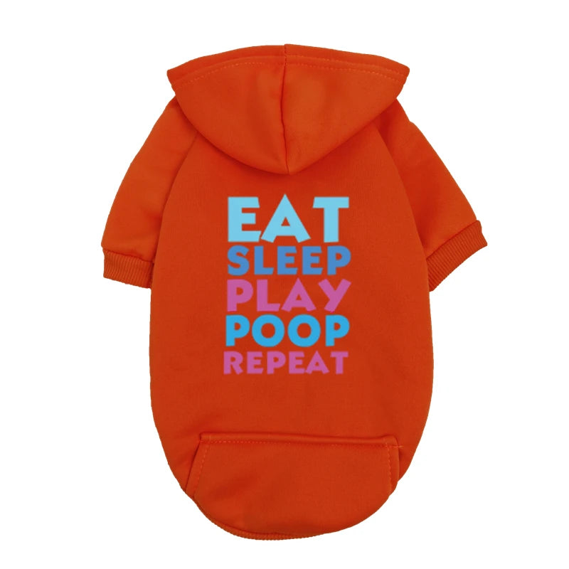 An orange hoodie with white text on the back that reads Eat Sleep Play Poop Repeat