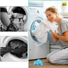 A woman is using reusable lint catchers inside a washing machine drum to remove lint from laundry.