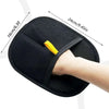 A hand is using a black reusable double-sided pet hair removal glove on a finger.