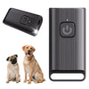 A black portable ultrasonic dog repeller device shown next to a dog.