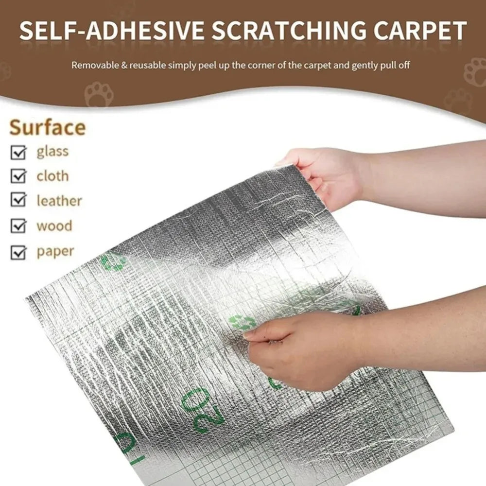 A close-up of a silver self-adhesive scratching carpet being peeled off a surface like glass or wood.