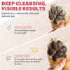 A hand holds a cat's paw, showing the difference between dirty and thoroughly cleaned paw pads.
