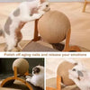 A cat is interacting with a Ferris Wheel Cat Scratcher featuring a rotating sisal ball for scratching and emotional release.