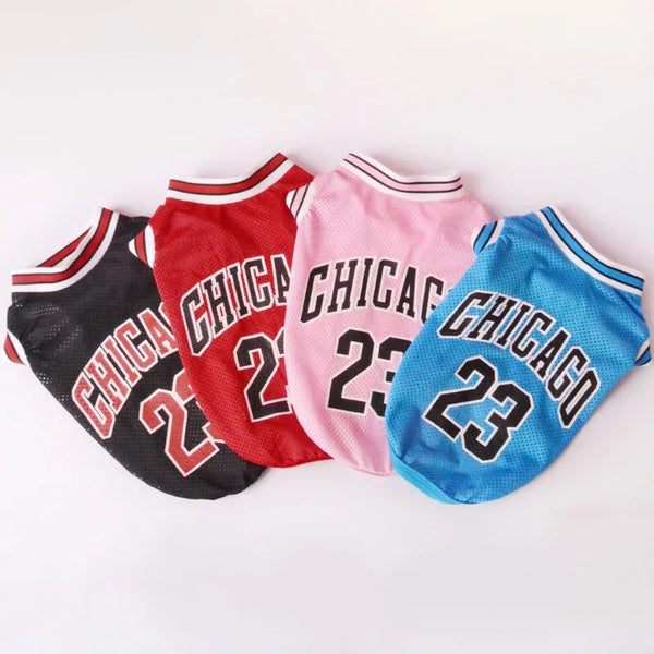 A set of three dog pet vests or jerseys in red, pink, and blue with Chicago text and the number 23.