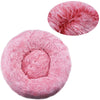A pink ultra-soft plush pet bed for dogs and cats, shown in two circular views.