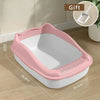 A pink high-sided cat litter box with a white interior and anti-splash design shown on a wooden floor.