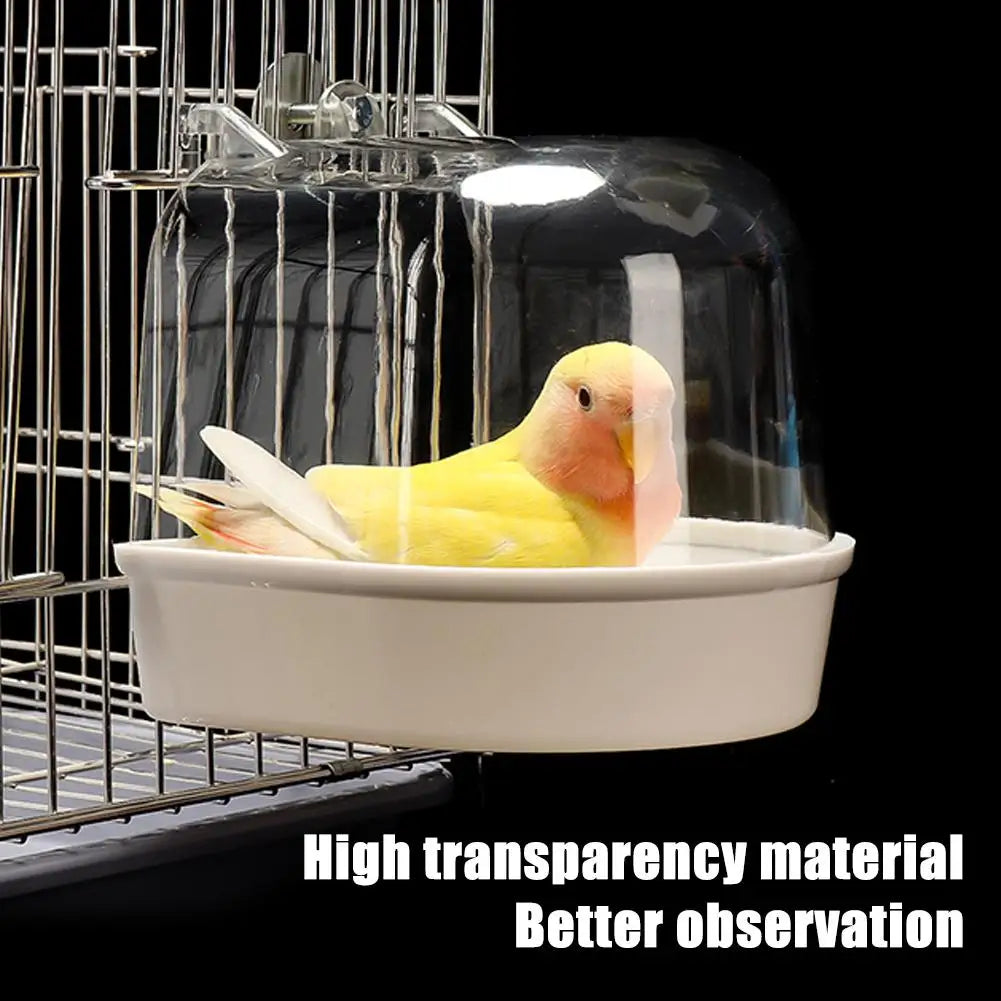 A clear plastic hanging bird bath with a wire cage structure for parakeets.