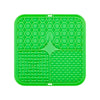 A bright green silicone lick mat with a honeycomb pattern for dog training and slow food.
