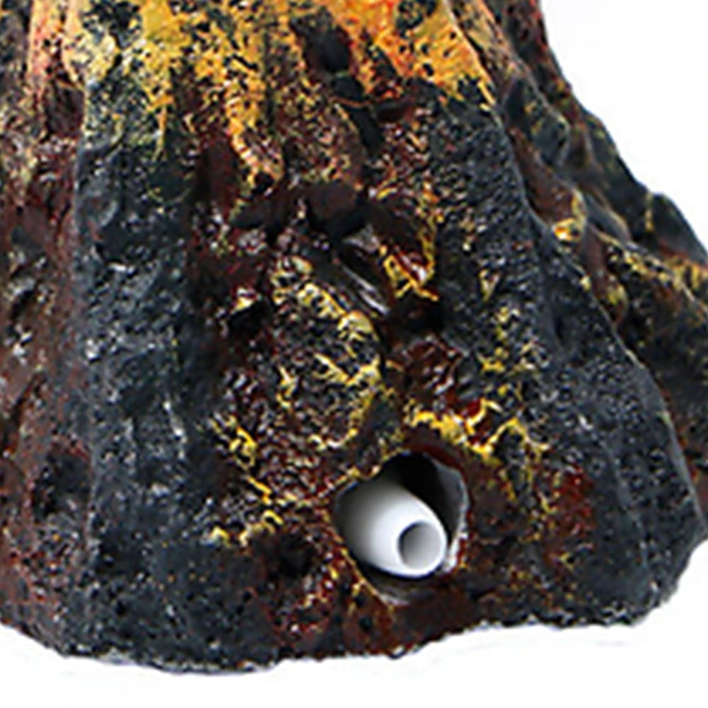 A dark, porous volcanic rock with a hole, used as an aquarium decoration.