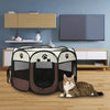 A portable foldable pet playpen with a black and gray fabric design resting on a wooden floor.